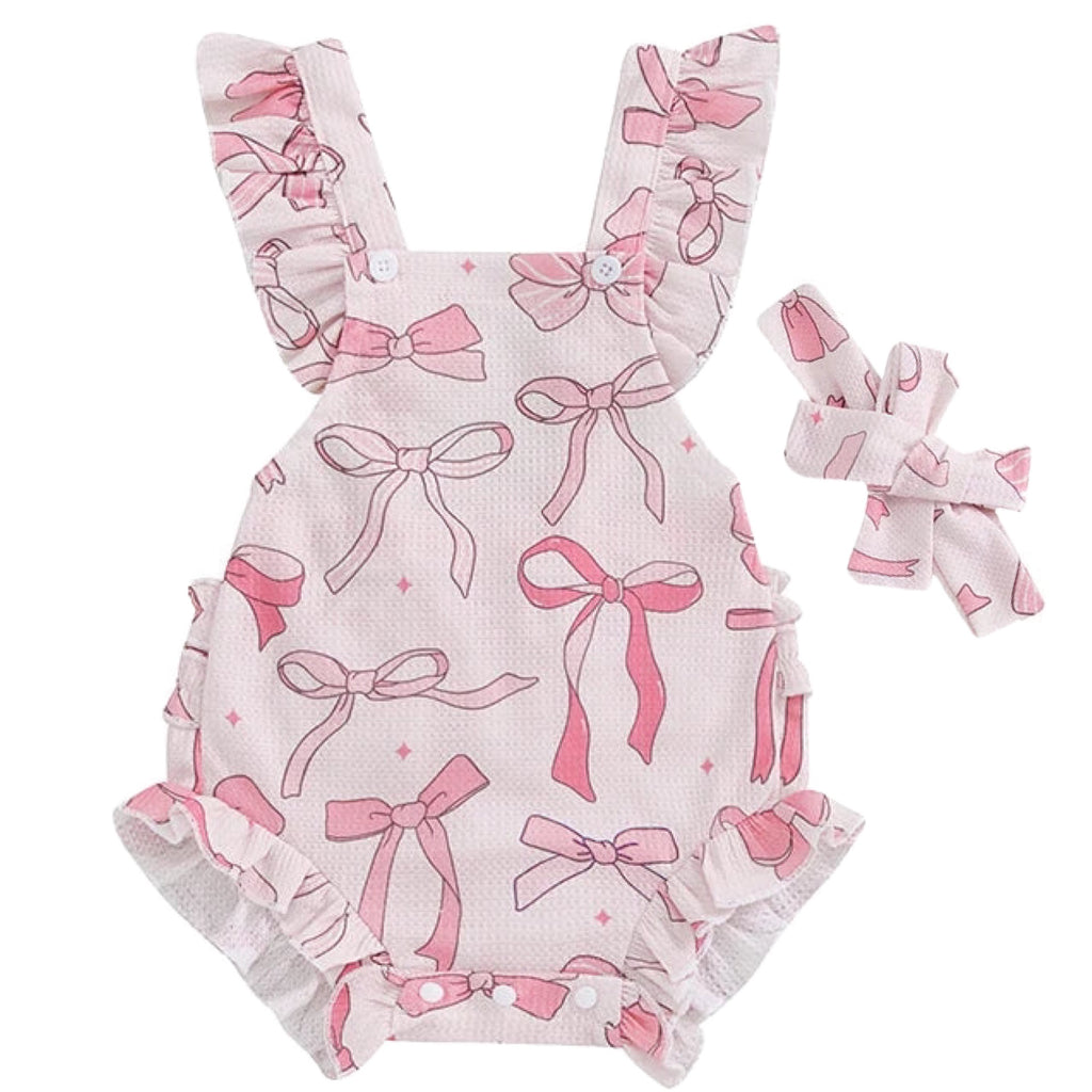 This is a baby girl romper in pink with ruffles and bow prints